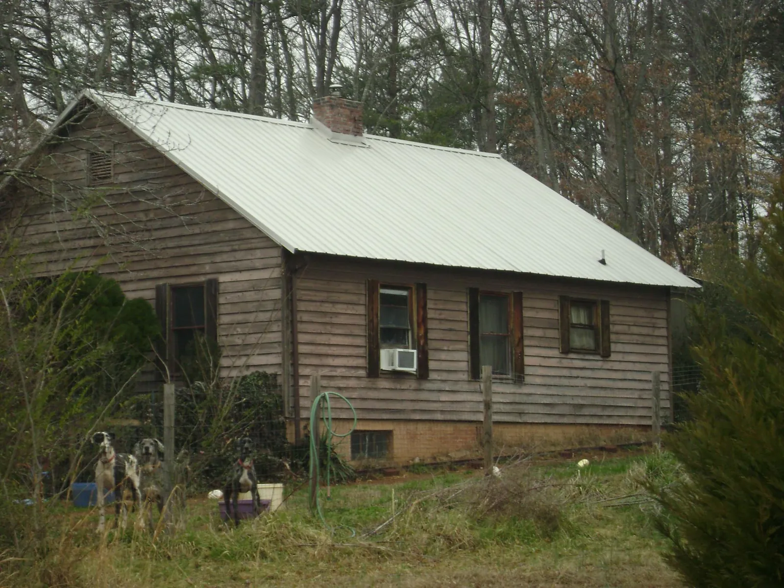 White metal roof on an old wood sided farmhouse in Greenbrier